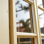 Sash window renovation showing restored wooden sash windows with fresh paint and new glass in a bright, classic home interior setting.